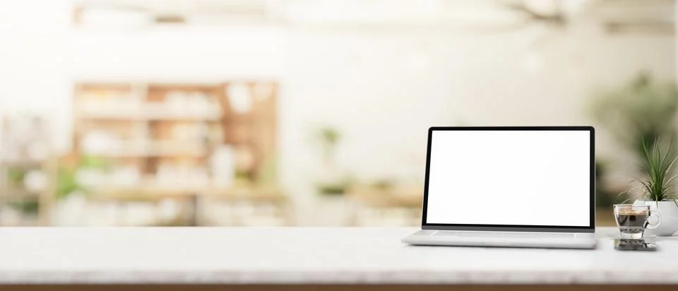 A laptop computer and a presentation space on a marble table in a cosy, con.. Stock Illustration