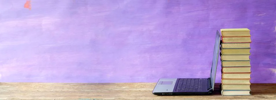 Laptop computer and stack of books, e-learning, homeschooling, online lesson Stock Photos