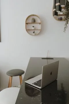 Laptop computer on bar counter and stools. Interior decoration details. Work  Stockfoto's