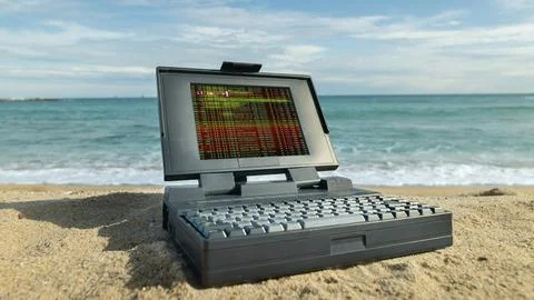 Laptop computer on a beach with data and code on screen Stock Photos