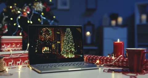 Laptop computer being on the table among wrapped Christmas presents in the Stock Footage 99805529