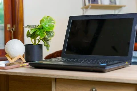 Laptop computer with a blank black screen in the office Stock Photos