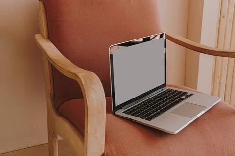 Laptop computer with blank copy space screen on chair Stock Photos