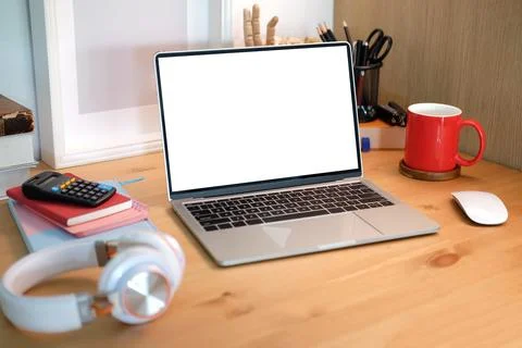 Laptop computer with blank display, red coffee cup and wireless headphone on  Stock Photos