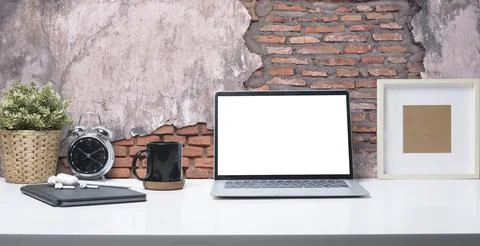 Laptop computer with blank screen, coffee cup, picture frame and potted pla.. Stock Photos