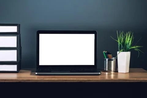Laptop computer with blank screen on office desktop Stock Photos