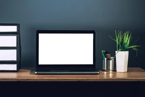 Laptop computer with blank screen on office desktop Stock Photos