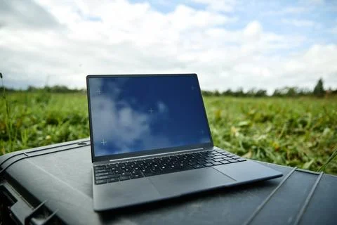 Laptop Computer with Blank Screen Placed Outdoors for Remote Work 写真素材