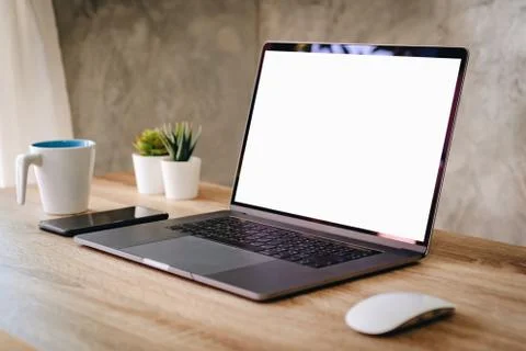 Laptop computer with blank screen on table. Stock Photos