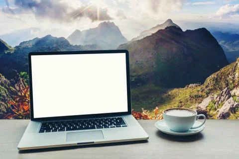 Laptop computer with blank white screen on table Stock Photos