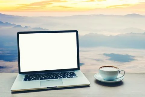 Laptop computer with blank white screen on table Stock Photos