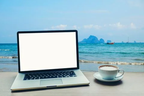 Laptop computer with blank white screen on table Stock Photos