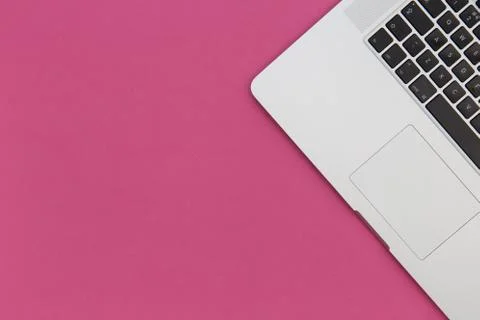 Laptop computer on bright pink background Foto stock