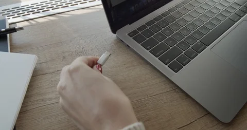 Laptop computer charging. Hand holding laptop power cable. Stock Footage 127284461