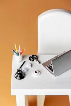 Laptop computer, coffee cup and pencils on a table Stock Photos