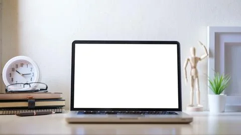 Laptop computer, coffee cup, potted plant and picture frame on creative wor.. Stock Photos