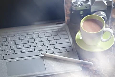 Laptop computer , coffee, old 35 film camera Stock Photos