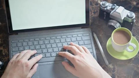Laptop computer , coffee, old 35 film camera Stock Photos