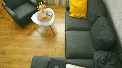 Laptop computer by coffee table, portable desk on grey sofa with yellow pil.. Vidéo 232889799