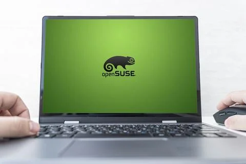 Laptop computer displaying logo of The openSUSE Project, a worldwide effort t Stock Photos