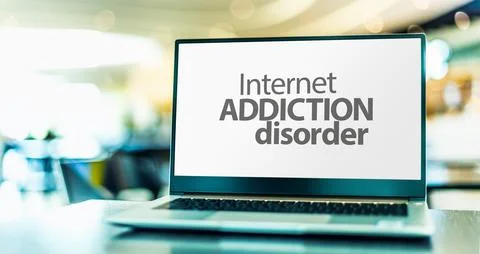 Laptop computer displaying the sign of Internet addiction disorder, a problem Stock Photos