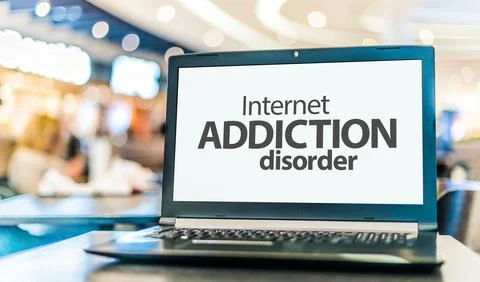 Laptop computer displaying the sign of Internet addiction disorder, a problem Stock Photos