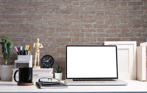 Laptop computer with empty display, coffee cup, picture frame and stationer.. Stock Photos