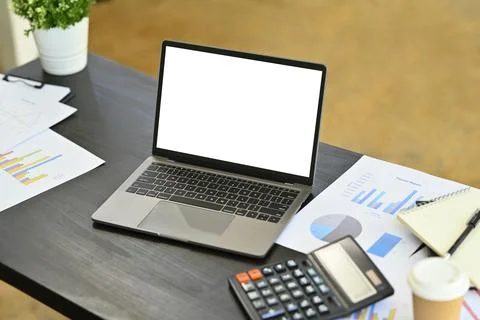 Laptop computer with empty screen, calculator and financial documents on office Stock Photos