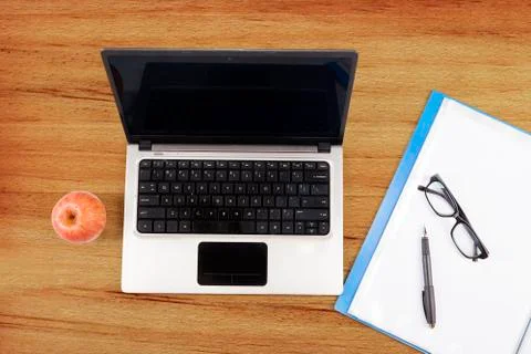 Laptop computer, folder, and apple Stock Photos