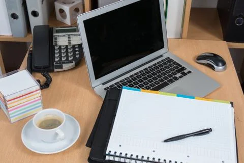 Laptop  computer with folder on desk at office 스톡 사진