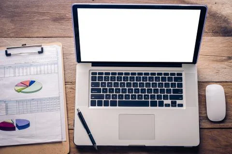 Laptop computer graph with office accessories on wooden table Stock Photos