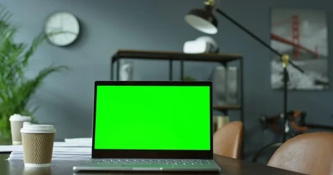 Laptop computer with green screen and coffee to-go on the desk for the reunions 스톡 동영상 104987310