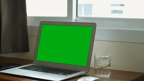 A laptop computer with a green screen chroma key set on work office table near t Video stock 112378178