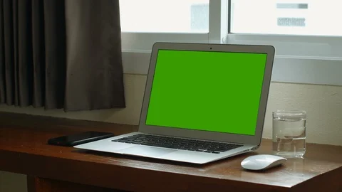 A laptop computer with a green screen chroma key set on work office table near t Stock Footage 112379024