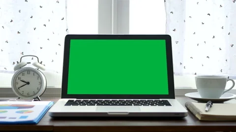 Laptop computer with a green screen chroma key near window with white curtain Stock Footage 131757767