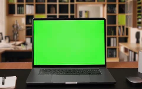 Laptop computer with Green screen Mock-up on working desk in office with no peop Stock Photos