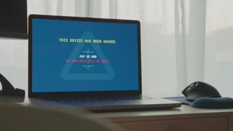 Laptop computer is hacked and displays message on screen of system breach Stock Footage 342512214