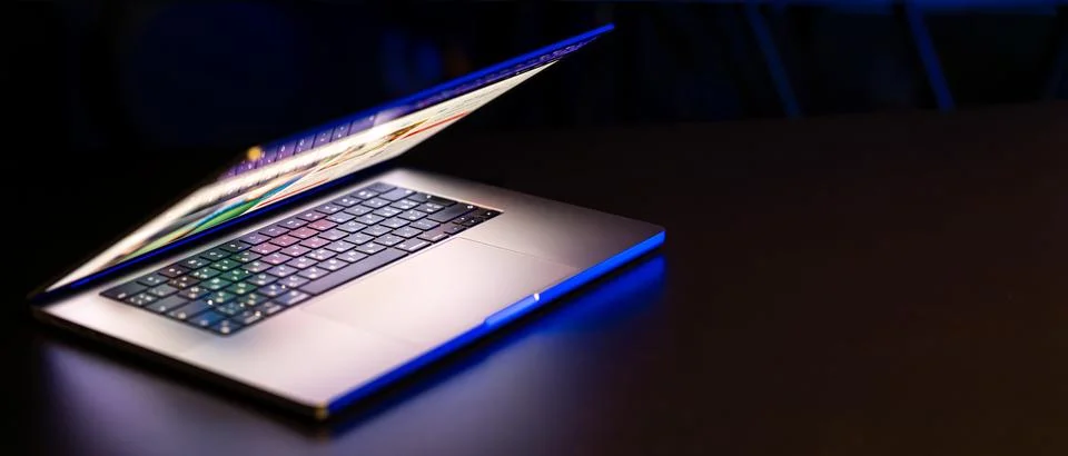 A laptop computer with a half-open screen on a dark background. Copy space. 写真素材