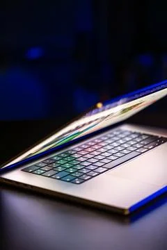 A laptop computer with a half-open screen on a dark background. Copy space. 写真素材