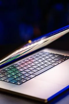 A laptop computer with a half-open screen on a dark background. Copy space. 写真素材