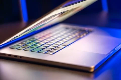 A laptop computer with a half-open screen on a dark background. Foto stock