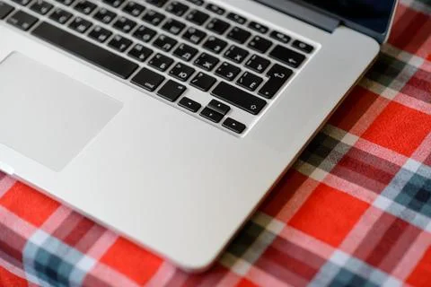 Laptop Computer on the Home Table Covered with Traditional Red Checkered Ta.. Stock Photos