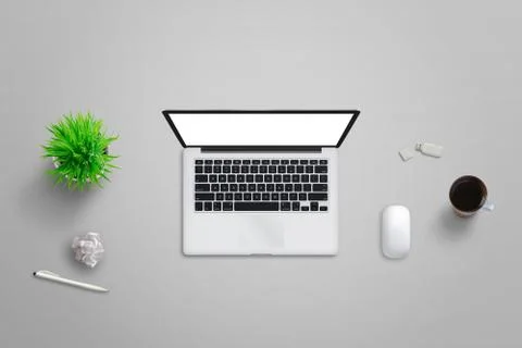 Laptop computer with isolated screen. Top view of office desk with plant, cof Stock Photos