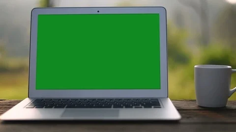  A laptop computer with a key green screen set on work office table. Stock Footage 97854061