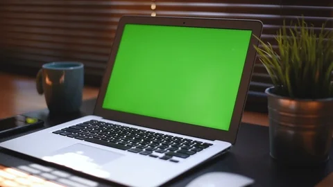 A laptop computer with a key green screen set on work office table. Stock Footage 98274376