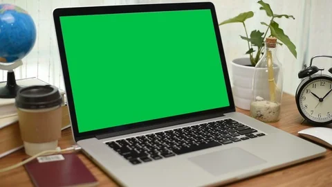 A laptop computer with a key green screen set on work office table. Stock Footage 103372666