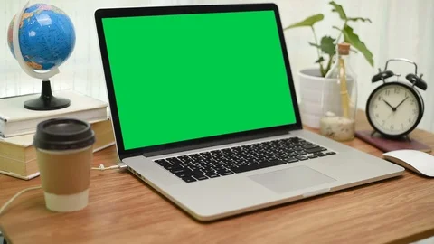 A laptop computer with a key green screen set on work office table. Stock Footage 103383308