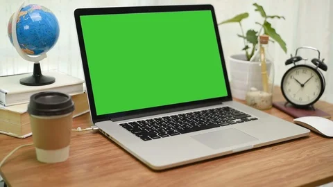 A laptop computer with a key green screen set on work office table. Stock Footage 105092941