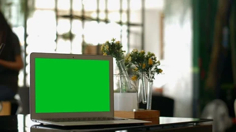 A laptop computer with a key green screen set on coffee shop. Video stock 112372758