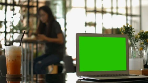A laptop computer with a key green screen set on coffee shop. Stock Footage 112372759